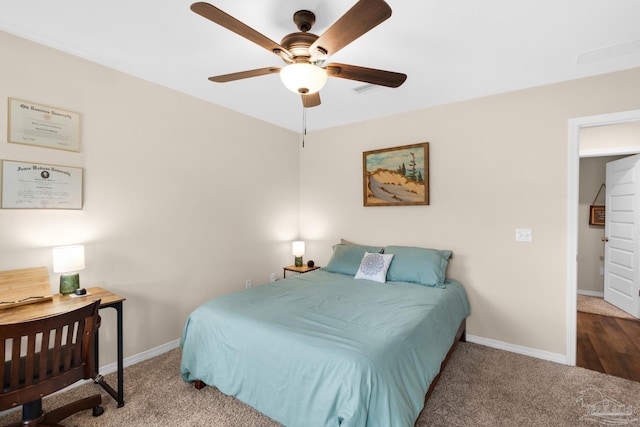 carpeted bedroom featuring a ceiling fan and baseboards