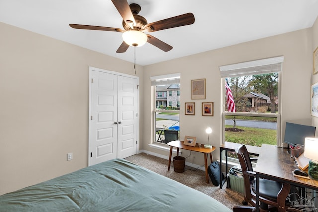 bedroom featuring a closet, carpet flooring, a ceiling fan, and baseboards