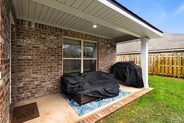 view of patio / terrace featuring area for grilling and fence