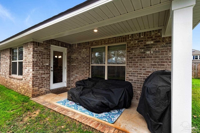 view of patio featuring a grill and fence