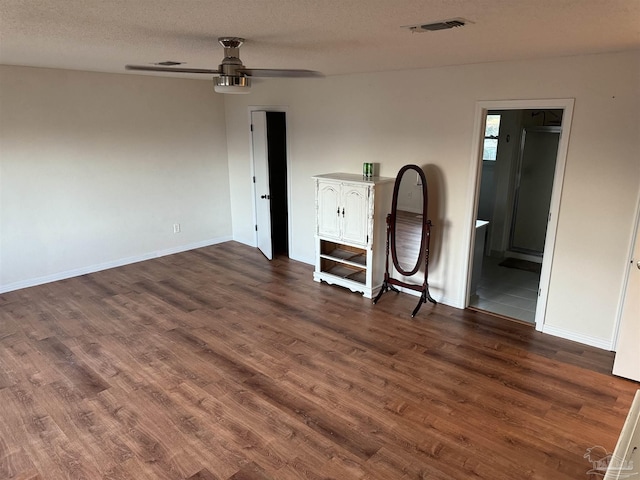 8156 Pompano St, Navarre, FL 32566 - unfurnished bedroom with dark wood-type flooring, a textured ceiling, and baseboards