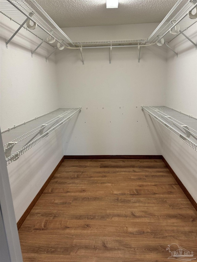 8156 Pompano St, Navarre, FL 32566 - walk in closet featuring wood finished floors