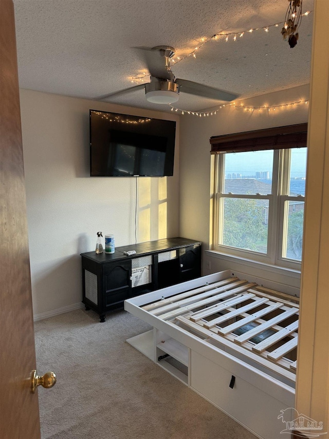 8156 Pompano St, Navarre, FL 32566 - bedroom featuring baseboards, ceiling fan, carpet flooring, and a textured ceiling
