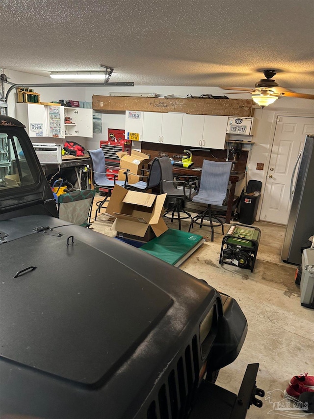 garage with ceiling fan and stainless steel fridge