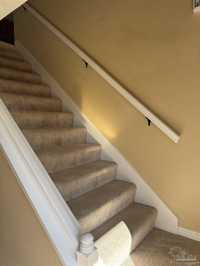 stairs featuring carpet