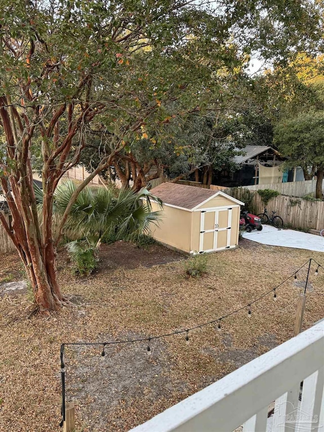 8156 Pompano St, Navarre, FL 32566 - view of yard featuring an outbuilding, a shed, and a fenced backyard