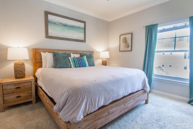 bedroom featuring ornamental molding and carpet floors