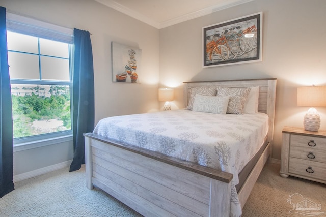 carpeted bedroom featuring baseboards and ornamental molding