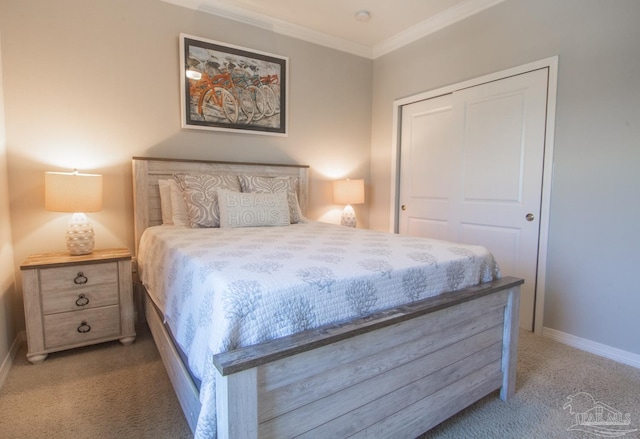 bedroom with carpet floors, a closet, crown molding, and baseboards