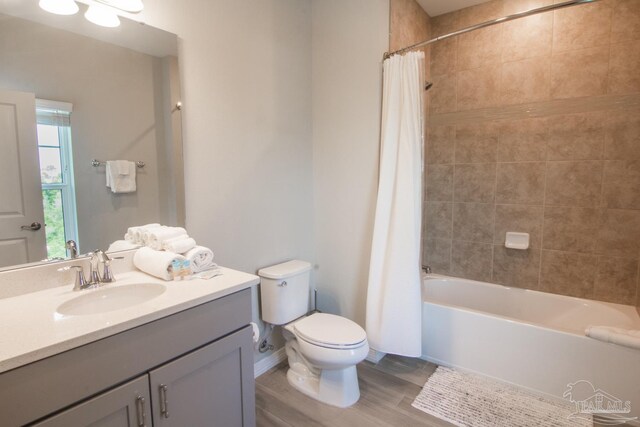 full bathroom with shower / bath combo with shower curtain, vanity, and toilet