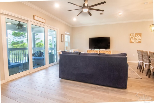 living room featuring ceiling fan, crown molding, and light hardwood / wood-style flooring