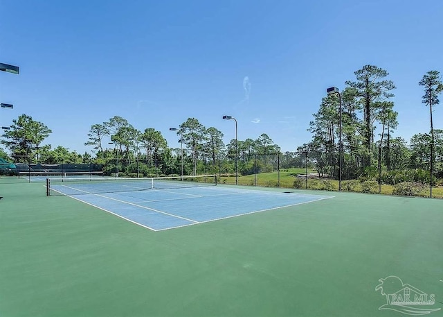 view of sport court featuring fence