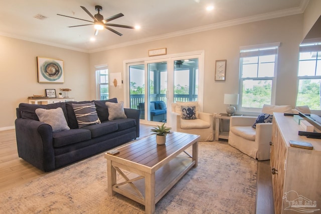 living room with light hardwood / wood-style flooring, ornamental molding, and ceiling fan