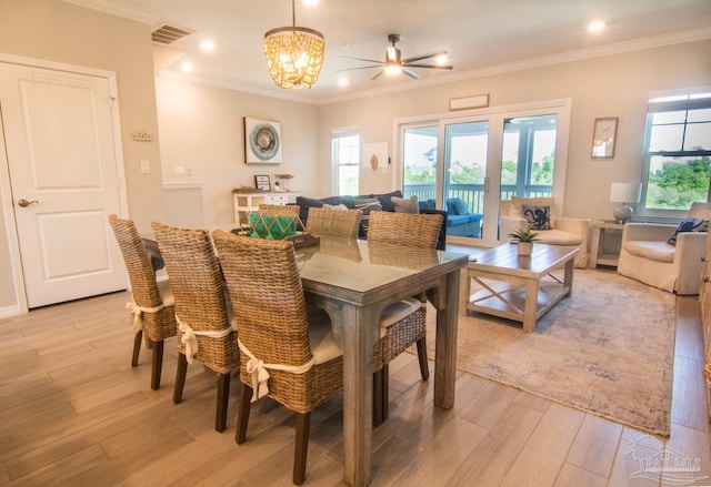 dining area with light wood finished floors, recessed lighting, visible vents, an inviting chandelier, and ornamental molding