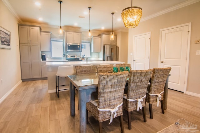 kitchen featuring appliances with stainless steel finishes, a spacious island, a breakfast bar area, and light wood-style flooring