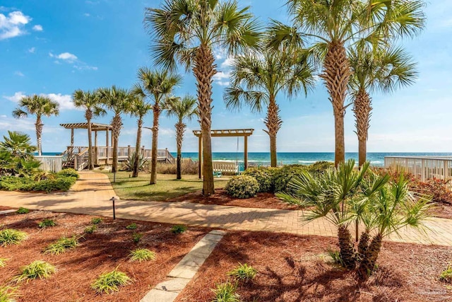 view of yard with a water view and a pergola