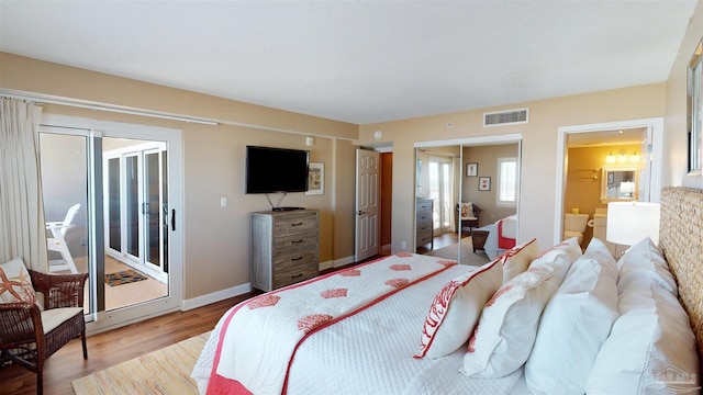 bedroom with baseboards, a closet, visible vents, and wood finished floors