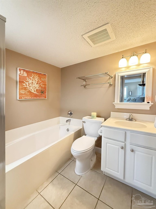 full bathroom with a garden tub, visible vents, toilet, vanity, and a textured ceiling