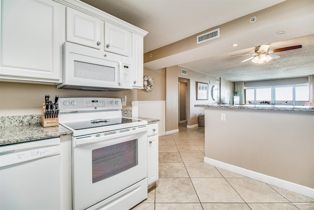 kitchen featuring white appliances, visible vents, white cabinets, and light tile patterned flooring