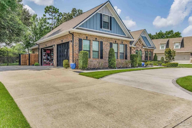 view of front of home with brick siding, board and batten siding, driveway, and fence