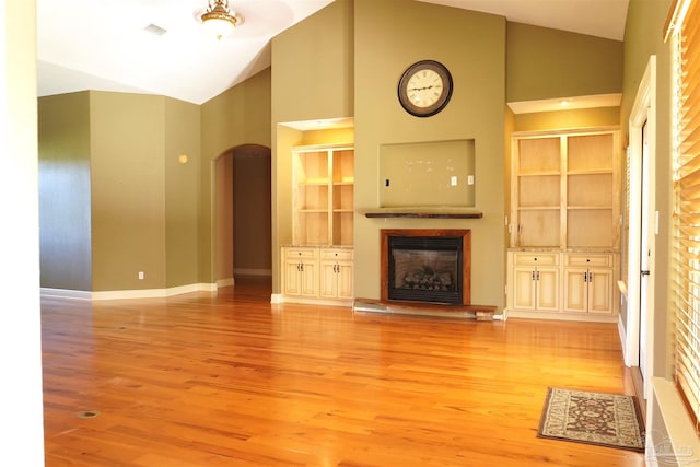 unfurnished living room featuring light hardwood / wood-style flooring and high vaulted ceiling