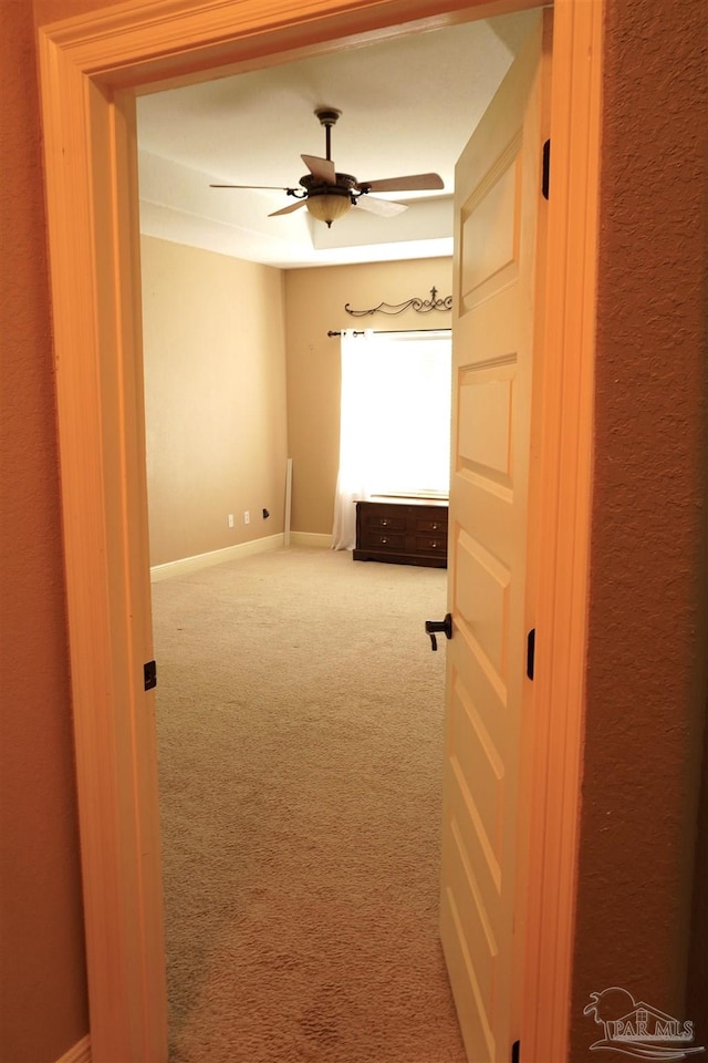 interior space featuring ceiling fan and carpet flooring