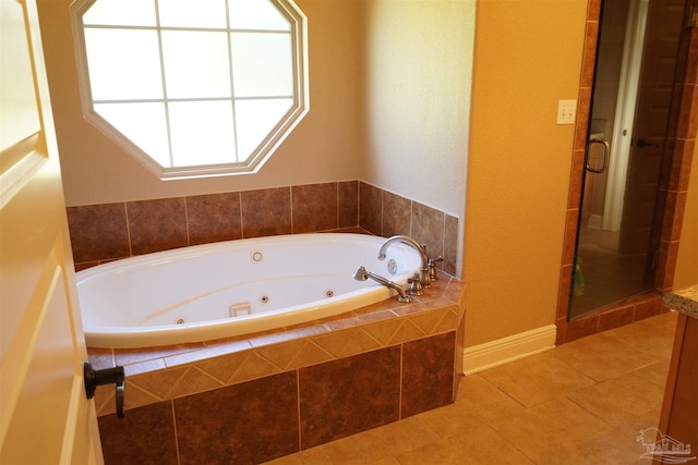 bathroom with independent shower and bath, tile patterned floors, and a healthy amount of sunlight