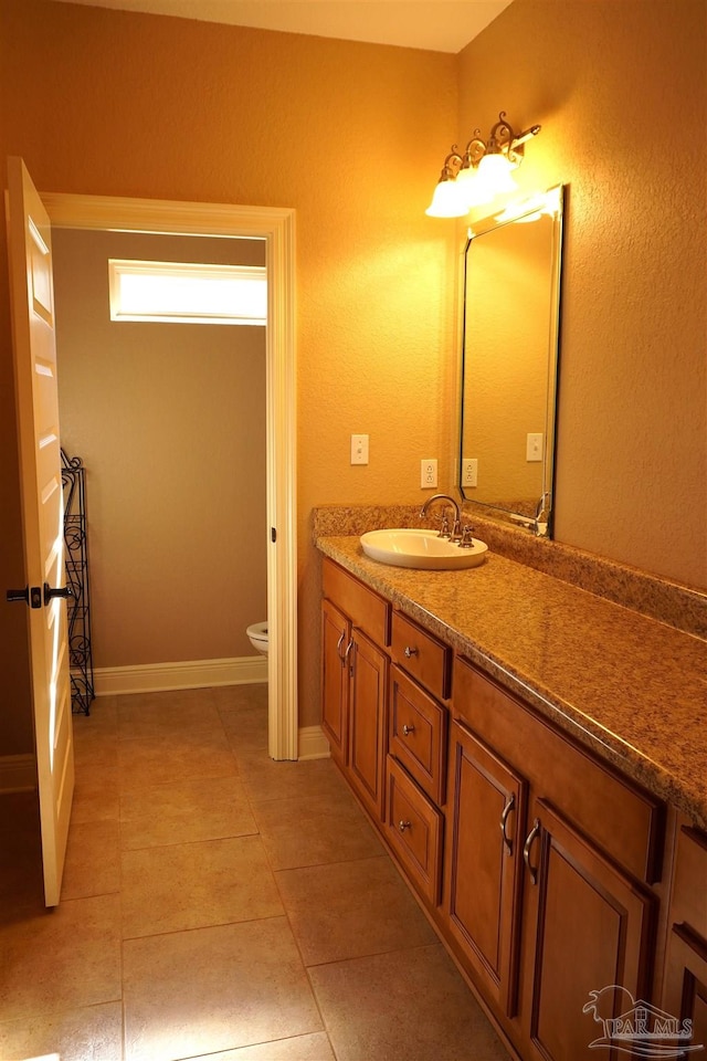 bathroom featuring vanity, toilet, and tile patterned floors