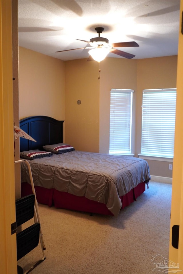 carpeted bedroom with ceiling fan