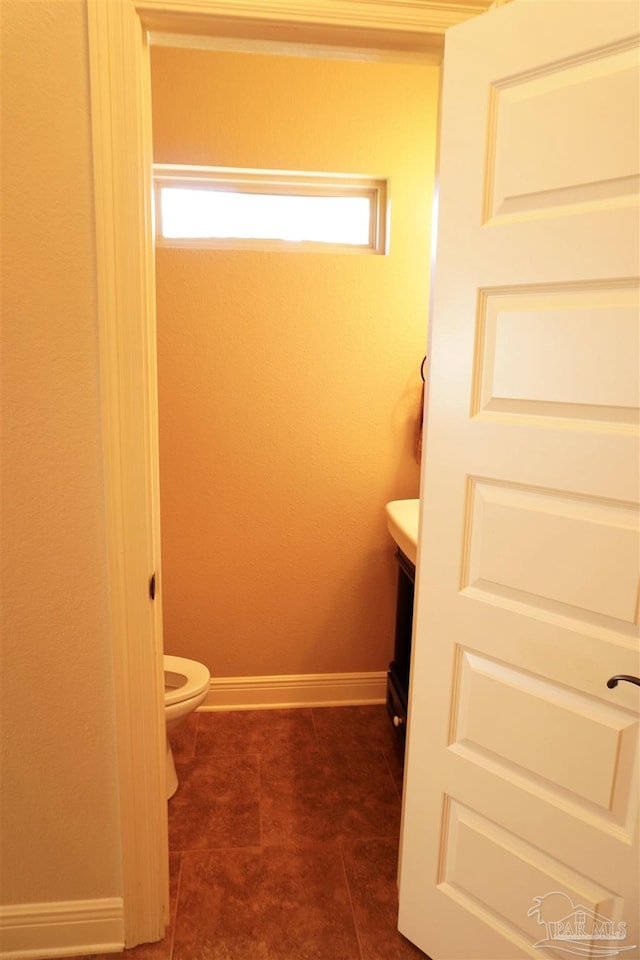 bathroom featuring vanity, toilet, and tile patterned floors