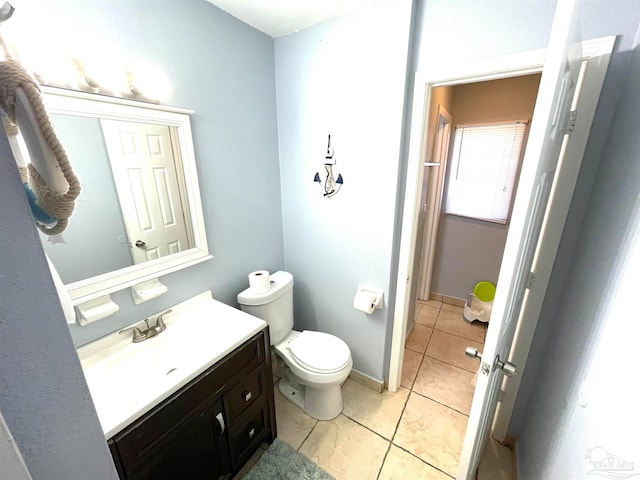 bathroom with vanity, toilet, and tile patterned floors