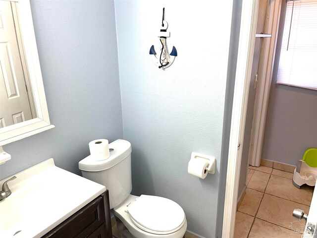 bathroom with vanity, toilet, and tile patterned floors