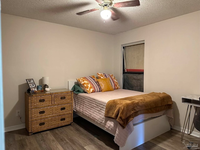 bedroom featuring ceiling fan, a textured ceiling, and dark hardwood / wood-style flooring