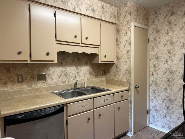 kitchen featuring light tile patterned floors, dishwasher, and sink