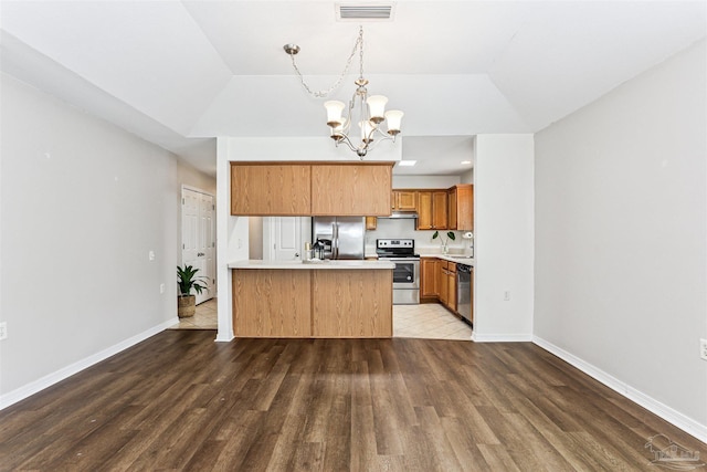 5397 Fawn Ridge Dr, Gulf Breeze, FL 32563 - kitchen with appliances with stainless steel finishes, a chandelier, light countertops, a peninsula, and wood finished floors