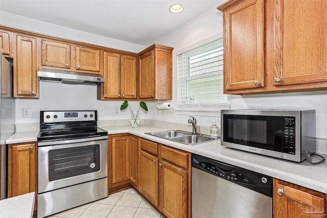 5397 Fawn Ridge Dr, Gulf Breeze, FL 32563 - kitchen with stainless steel appliances, under cabinet range hood, light countertops, light tile patterned floors, and recessed lighting