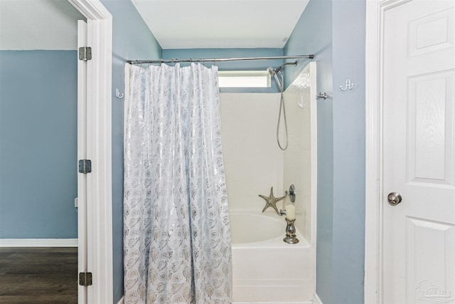 5397 Fawn Ridge Dr, Gulf Breeze, FL 32563 - bathroom featuring shower / bathtub combination with curtain and wood finished floors