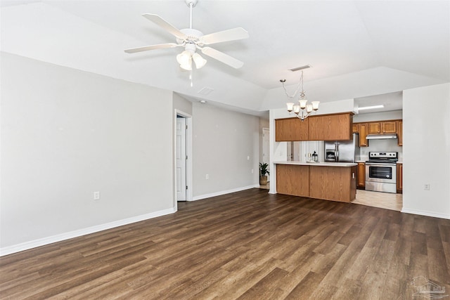 5397 Fawn Ridge Dr, Gulf Breeze, FL 32563 - kitchen featuring stainless steel appliances, under cabinet range hood, brown cabinetry, open floor plan, and a chandelier