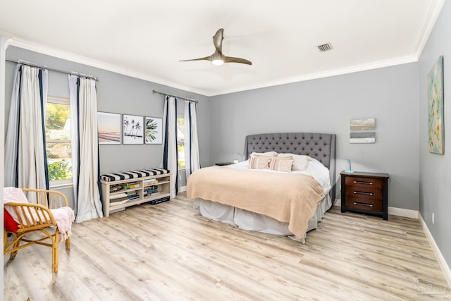 bedroom with visible vents, light wood-style flooring, baseboards, ornamental molding, and ceiling fan