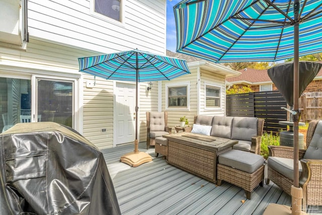 wooden deck with grilling area, an outdoor living space, and fence