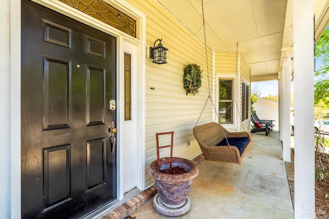 property entrance featuring a porch and crawl space