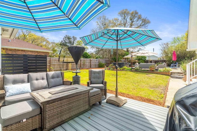 deck featuring an outdoor hangout area, a lawn, and fence private yard