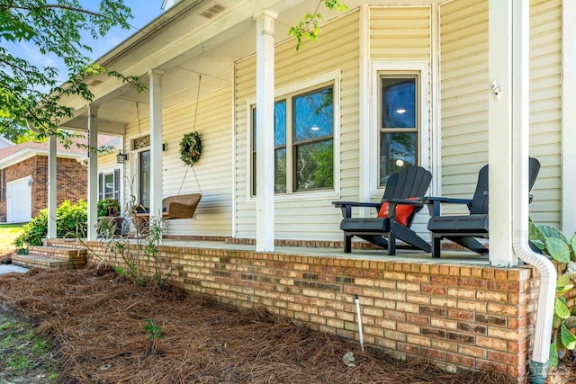 entrance to property featuring covered porch