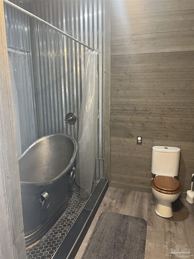 5350 Pale Moon Dr, Pensacola, FL 32507 - bathroom with wood walls, toilet, a shower with curtain, and wood finished floors