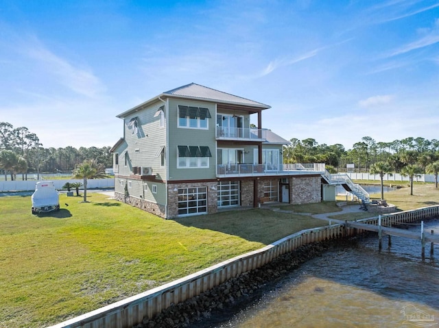 5350 Pale Moon Dr, Pensacola, FL 32507 - rear view of house with a water view, stairs, a lawn, metal roof, and a balcony