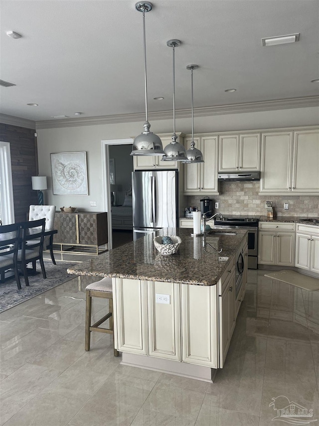 5350 Pale Moon Dr, Pensacola, FL 32507 - kitchen featuring under cabinet range hood, stainless steel appliances, cream cabinetry, and crown molding