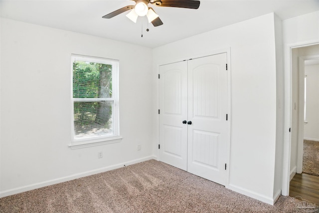 4248 Seaport Rd, Pace, FL 32571 - unfurnished bedroom featuring carpet, a closet, baseboards, and a ceiling fan
