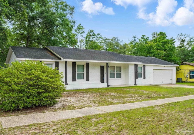 4248 Seaport Rd, Pace, FL 32571 - ranch-style house featuring a garage, covered porch, brick siding, a front yard, and central AC unit