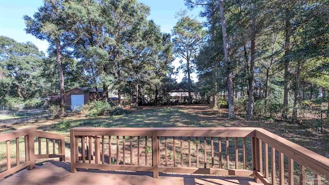 wooden terrace featuring a storage unit