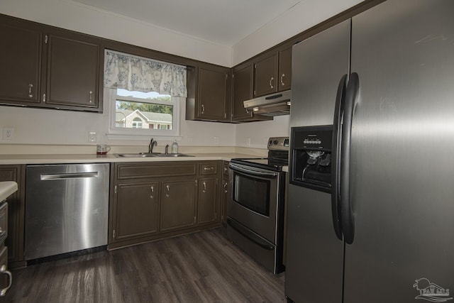 kitchen with dark wood finished floors, stainless steel appliances, light countertops, a sink, and under cabinet range hood